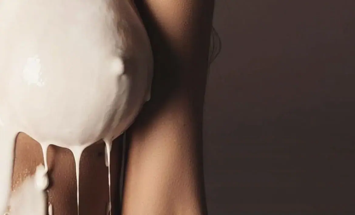 Close-up artistic photo of a torso with white cream dripping down the skin, used for 24hour Las Vegas Massage in Las Vegas