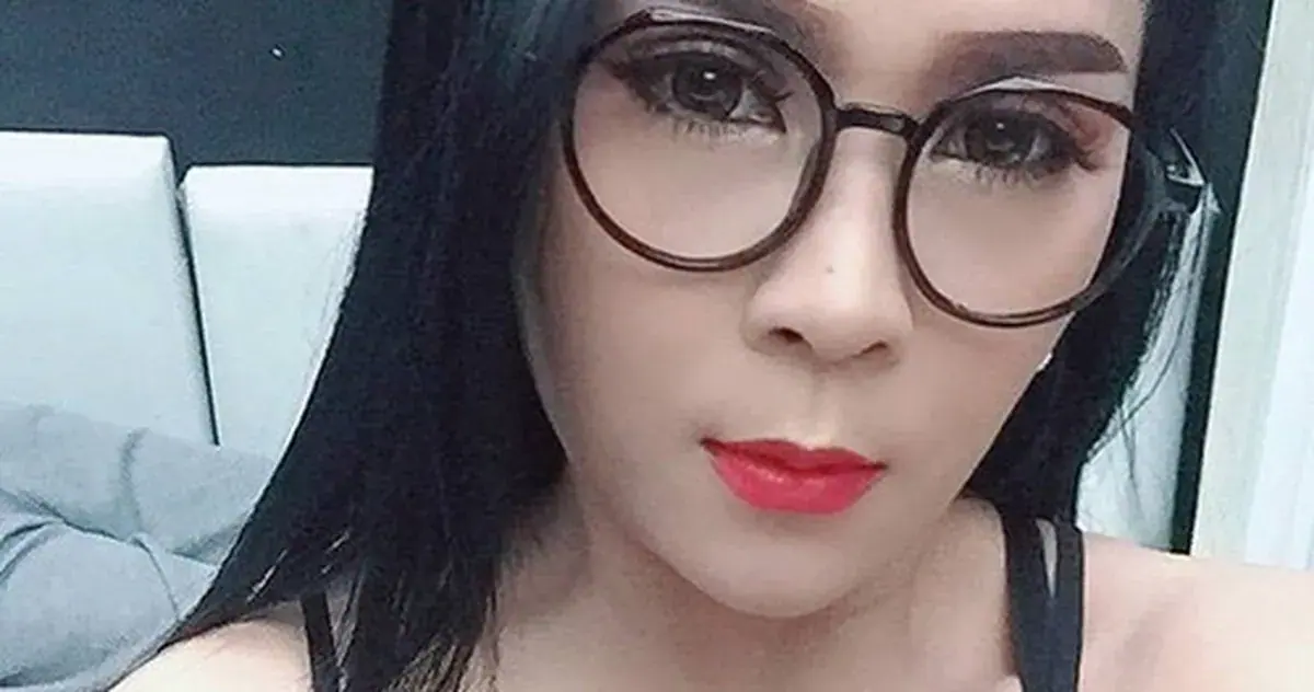 Selfie-style portrait of a woman with long black hair, round glasses and red lipstick, for Annies Massage in Bangkok