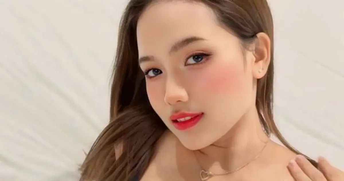 Portrait of a young woman with long brown hair and red lipstick, used for Boss Massage in Bangkok