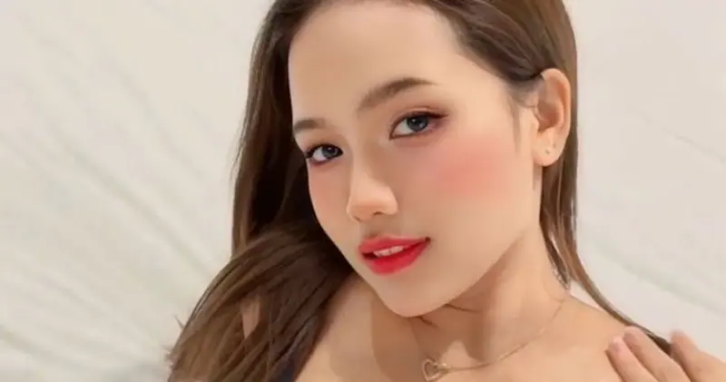 Portrait of a young woman with long brown hair and red lipstick, used for Boss Massage in Bangkok