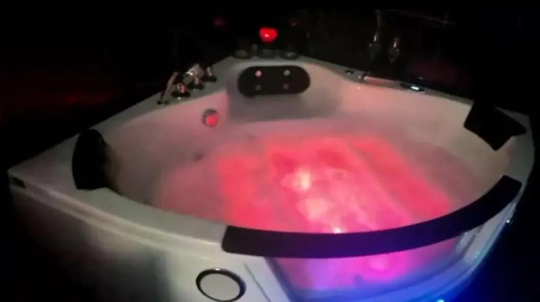 Illuminated jacuzzi with red ambient lighting at Erotic Massage -Velvet Touch in Prague