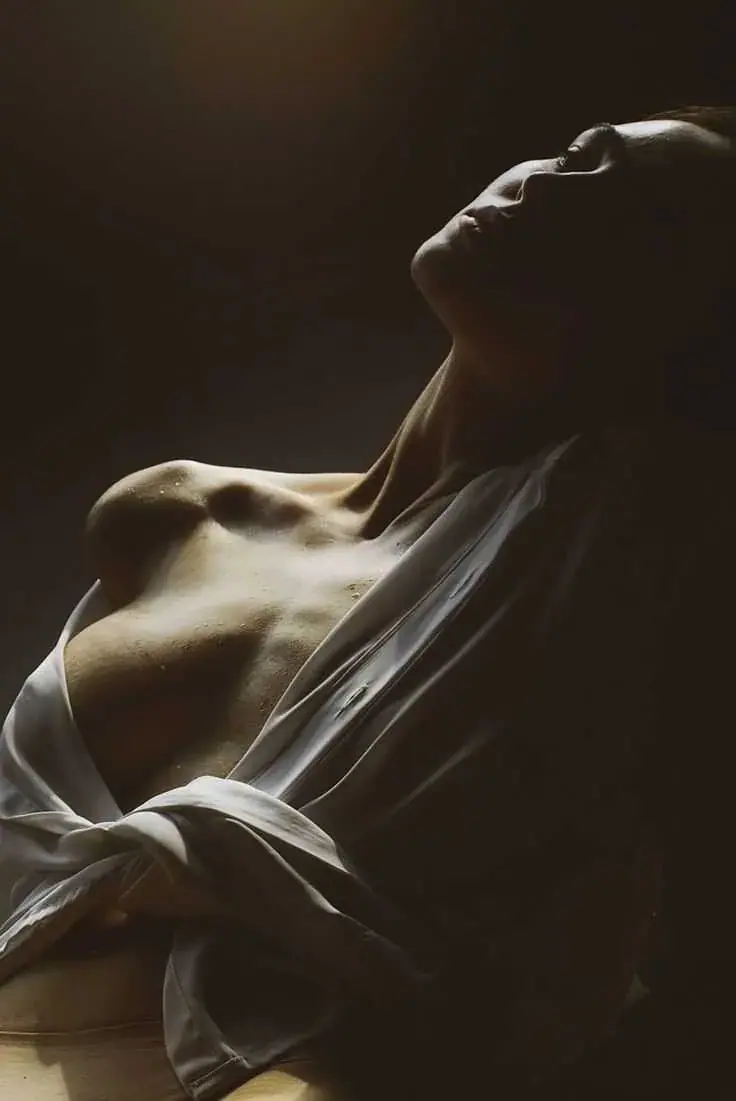 Sensual masseuse in dramatic lighting at Heaven Prime erotic massage salon in Bangkok