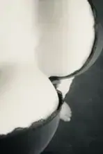 Abstract black-and-white close-up of smooth, curving white shapes against a dark background, used for Hot Vegas Touch in