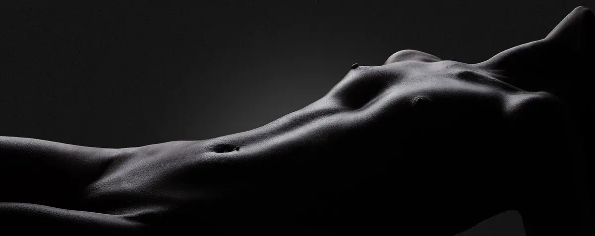 Artistic black and white photo of a woman's body contours representing Peach Massage in Bangkok