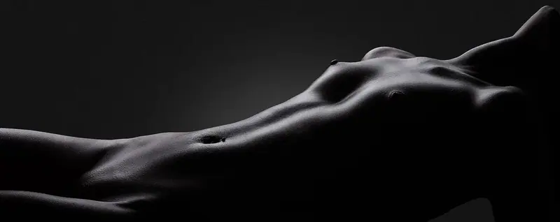 Artistic black and white photo of a woman's body contours representing Peach Massage in Bangkok