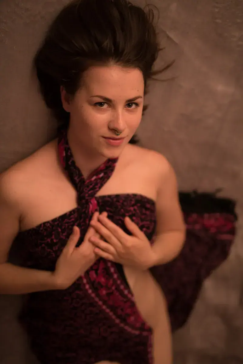 Portrait of a masseuse wrapped in patterned fabric at Salon Kaira Sayah in Brno