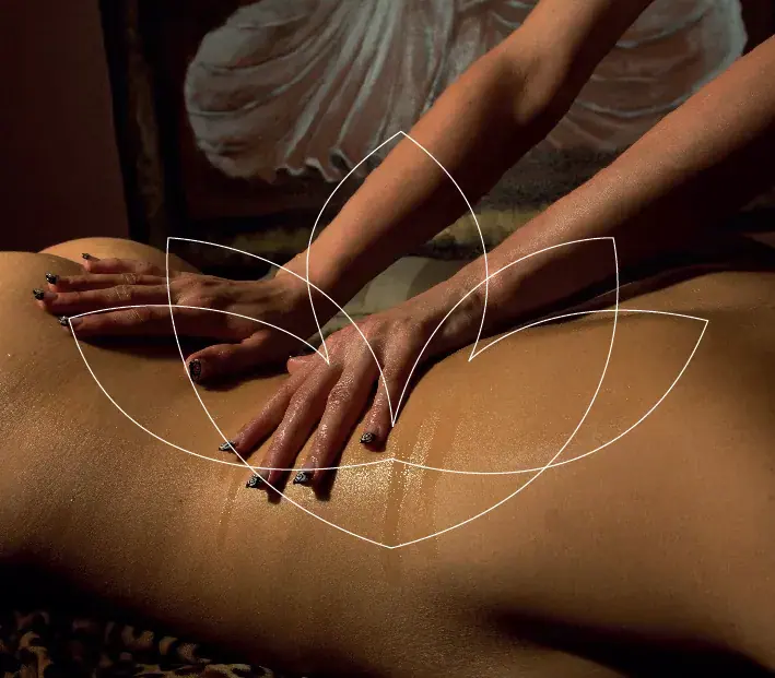 A masseuse's oiled hands working on a client's back at Studio Despacio, a massage salon in Brno