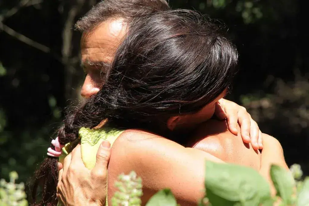 A man and a woman sharing an intimate embrace outdoors at Tamás Kinga in Budapest
