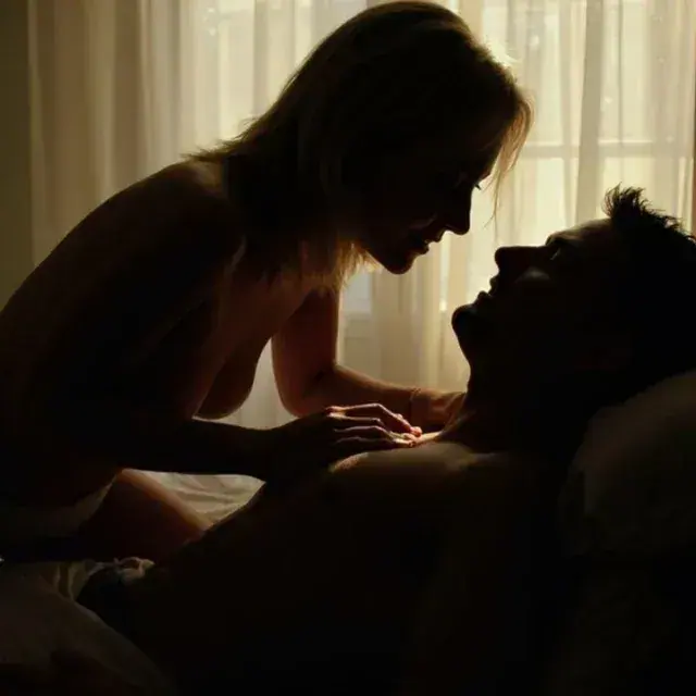 Silhouetted couple in an intimate moment by a sheer-curtained window at Tantra Goddess in Las Vegas