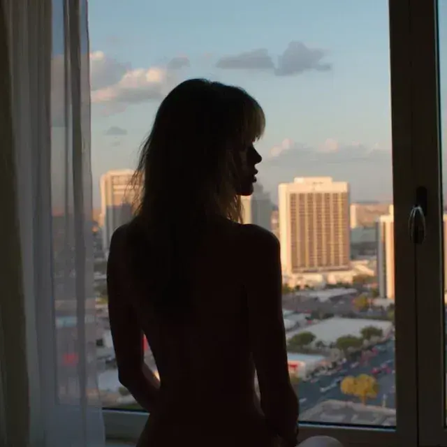 Silhouette of a masseuse by a window overlooking the skyline at Tantra Goddess Las Vegas