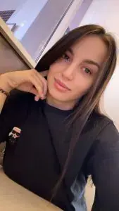 Selfie of a young woman with long dark hair in a black sweater, resting her chin on her hand, at Tantric Moskow in Moscow