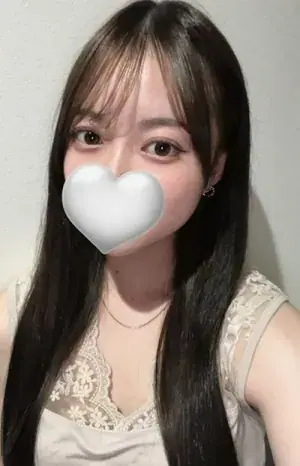 Selfie-style portrait of a woman with long dark hair and a heart-shaped cover over her face, at Ultimate Spa in Tokyo